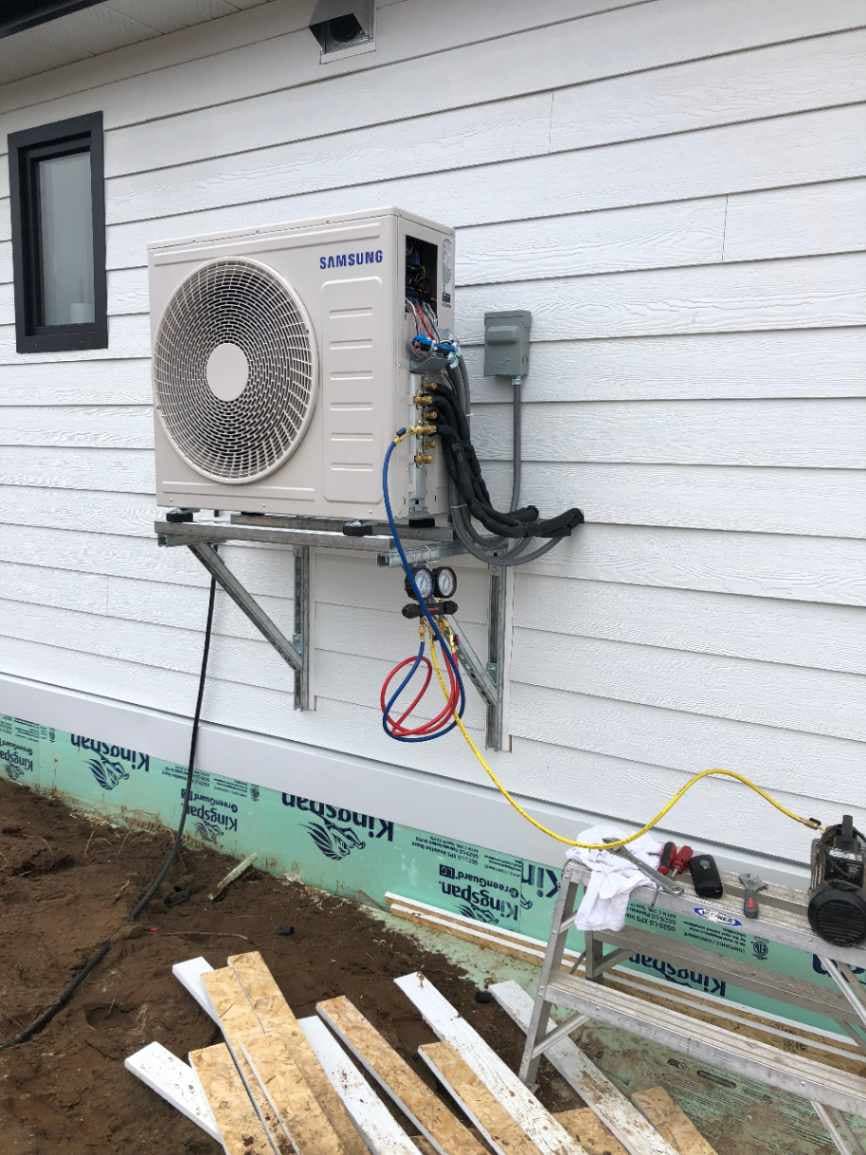 Outdoor ductless mini-split condenser unit on a Total Climate install
