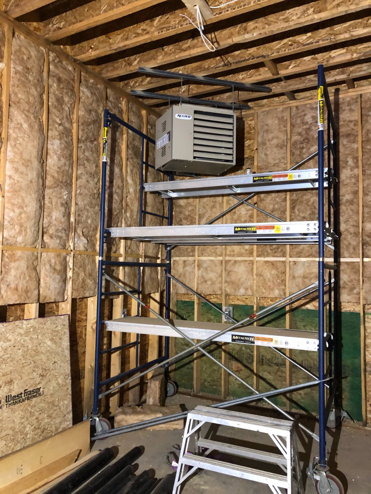 Suspended gas-fired unit heater in a garage or commercial bay